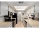 Bright kitchen features white cabinets, black appliances, and a well-lit countertop, ideal for cooking at 145 N 74Th St # 251, Mesa, AZ 85207