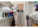 Organized walk-in closet with shelving, rods, cleaning supplies, ironing board and vacuum at 145 N 74Th St # 251, Mesa, AZ 85207