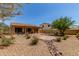 Private back yard with covered patio, desert landscaping, and a charming brick patio at 17891 W Badger Way, Goodyear, AZ 85338