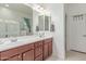 Bathroom with dual sinks, wood vanity, and ample counter space at 17891 W Badger Way, Goodyear, AZ 85338