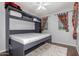 Bedroom featuring stylish Murphy bed and designer curtains at 17891 W Badger Way, Goodyear, AZ 85338