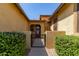 Inviting front entry with iron gate and desert landscaping showcasing great curb appeal at 17891 W Badger Way, Goodyear, AZ 85338
