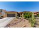 Charming single-story home features a desert-landscaped front yard with gravel and native plants at 17891 W Badger Way, Goodyear, AZ 85338