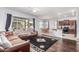 Spacious living room with dark wood floors, large windows and an open floor plan at 17891 W Badger Way, Goodyear, AZ 85338