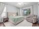 Bright main bedroom with large window, plush carpeting and neutral color palette at 17891 W Badger Way, Goodyear, AZ 85338