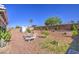 Low maintenance backyard with gravel, landscaping, and brick wall at 1937 W Burgess Ln, Phoenix, AZ 85041
