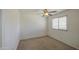 Cozy bedroom with a ceiling fan and a window providing natural light at 1937 W Burgess Ln, Phoenix, AZ 85041