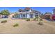 Charming two-story home featuring desert landscaping, decorative stone accents, and a welcoming front entrance at 1937 W Burgess Ln, Phoenix, AZ 85041