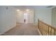 Upstairs hallway featuring neutral carpet and access to a bathroom at 1937 W Burgess Ln, Phoenix, AZ 85041
