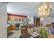Open kitchen view including stainless appliances, granite countertop, chandelier, and dining area at 1937 W Burgess Ln, Phoenix, AZ 85041