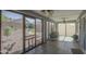 Relaxing sunroom filled with light from many screened windows looking out to the yard at 1937 W Burgess Ln, Phoenix, AZ 85041
