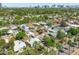 Aerial view showcasing neighborhood with palm trees, houses, and city skyline at 2041 N 16Th Ave, Phoenix, AZ 85007