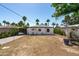 Expansive backyard highlighting the house's exterior, outdoor patio, and surrounding palm trees at 2041 N 16Th Ave, Phoenix, AZ 85007