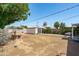Spacious backyard with a detached garage, complemented by mature trees and landscaping, perfect for outdoor enjoyment at 2041 N 16Th Ave, Phoenix, AZ 85007