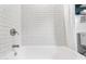 Close-up of the white porcelain bathtub with white subway tile walls and chrome fixtures at 2041 N 16Th Ave, Phoenix, AZ 85007