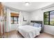 Cozy bedroom with wood floors, white walls, and a large window with natural light at 2041 N 16Th Ave, Phoenix, AZ 85007