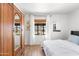 Well-lit bedroom with wood floors, wardrobe, and a large window dressed in sheer white curtains at 2041 N 16Th Ave, Phoenix, AZ 85007