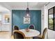 Elegant dining room with a blue accent wall, stylish lighting, and modern decor at 2041 N 16Th Ave, Phoenix, AZ 85007