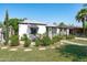 Charming single-story home featuring a patio with seating, manicured greenery, and a inviting walkway at 2041 N 16Th Ave, Phoenix, AZ 85007
