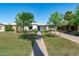 Inviting single-story home with a manicured lawn, mature trees, and a charming walkway to the front door at 2041 N 16Th Ave, Phoenix, AZ 85007