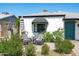 Charming single-story home featuring an inviting patio with chairs, lush greenery, and classic curb appeal at 2041 N 16Th Ave, Phoenix, AZ 85007