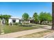 Attractive single-story home with a well-maintained lawn, mature trees, and a welcoming front porch area at 2041 N 16Th Ave, Phoenix, AZ 85007