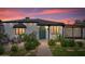 Charming single-story home featuring a vibrant front door, lush landscaping, and a cozy outdoor seating area at 2041 N 16Th Ave, Phoenix, AZ 85007