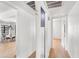 Bright hallway with white walls, hardwood floors, and doorways leading to adjacent rooms at 2041 N 16Th Ave, Phoenix, AZ 85007