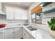 Stylish kitchen with white cabinets, quartz countertops, and open shelving at 2041 N 16Th Ave, Phoenix, AZ 85007
