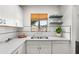 Modern kitchen featuring quartz countertops, sleek hardware, and a window with a view at 2041 N 16Th Ave, Phoenix, AZ 85007