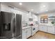 Bright kitchen with stainless steel appliances, white cabinetry, and a subway tile backsplash at 2041 N 16Th Ave, Phoenix, AZ 85007