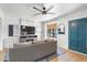 Cozy living room with a large sofa, ceiling fan, and a modern entertainment center at 2041 N 16Th Ave, Phoenix, AZ 85007