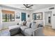 Comfortable living room featuring a gray couch, window, and a stylish white desk at 2041 N 16Th Ave, Phoenix, AZ 85007