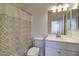 Clean bathroom with patterned shower curtain, updated vanity and new lighting at 218 E Milada Dr, Phoenix, AZ 85042