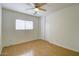 Bright bedroom with hardwood floors, closet and a ceiling fan at 218 E Milada Dr, Phoenix, AZ 85042