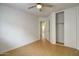 Bedroom boasts laminate flooring and large sliding door closet with ample natural light at 218 E Milada Dr, Phoenix, AZ 85042