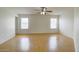 Spacious bedroom with light hardwood floors and two large windows providing natural light at 218 E Milada Dr, Phoenix, AZ 85042