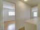 Hallway with view of the bedrooms; bright natural light, neutral walls, and tile floor at 218 E Milada Dr, Phoenix, AZ 85042