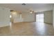 Open-concept living room with tile flooring and a sliding glass door to the patio at 218 E Milada Dr, Phoenix, AZ 85042