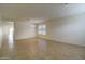 Spacious living area with tile floors, new lighting and a ceiling fan at 218 E Milada Dr, Phoenix, AZ 85042