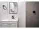 Well lit bathroom featuring modern fixtures and a stylishly tiled shower wall at 2443 E Randall Dr, Tempe, AZ 85288