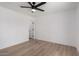 Minimalist bedroom features wood-look flooring and ceiling fan at 2443 E Randall Dr, Tempe, AZ 85288