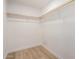Walk-in closet with wood laminate floors and ample shelving at 2443 E Randall Dr, Tempe, AZ 85288