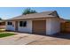 Side view of an updated single-story home with an attached garage and clean landscaping at 2443 E Randall Dr, Tempe, AZ 85288