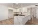 Bright kitchen features white cabinets, modern appliances, and a spacious waterfall island at 2443 E Randall Dr, Tempe, AZ 85288