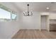 Bright kitchen area showcasing modern light fixture, hardwood flooring, and updated cabinets at 2443 E Randall Dr, Tempe, AZ 85288