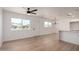 Open-concept living space with lots of natural light, updated flooring, and view to kitchen at 2443 E Randall Dr, Tempe, AZ 85288