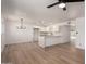 Bright living room with modern light fixture, hardwood flooring, and view to updated kitchen at 2443 E Randall Dr, Tempe, AZ 85288