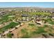 Aerial view of community pool, ramada, parking, green spaces, and surrounding homes at 2519 E Fortana Dr, San Tan Valley, AZ 85143