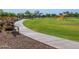 Scenic community park featuring a walking path, park benches, green space, and playground equipment at 2519 E Fortana Dr, San Tan Valley, AZ 85143